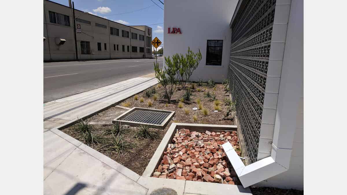 Shown here is a rain gutter directing rainwater into a bioretention (raingarden) at the LPA Office.