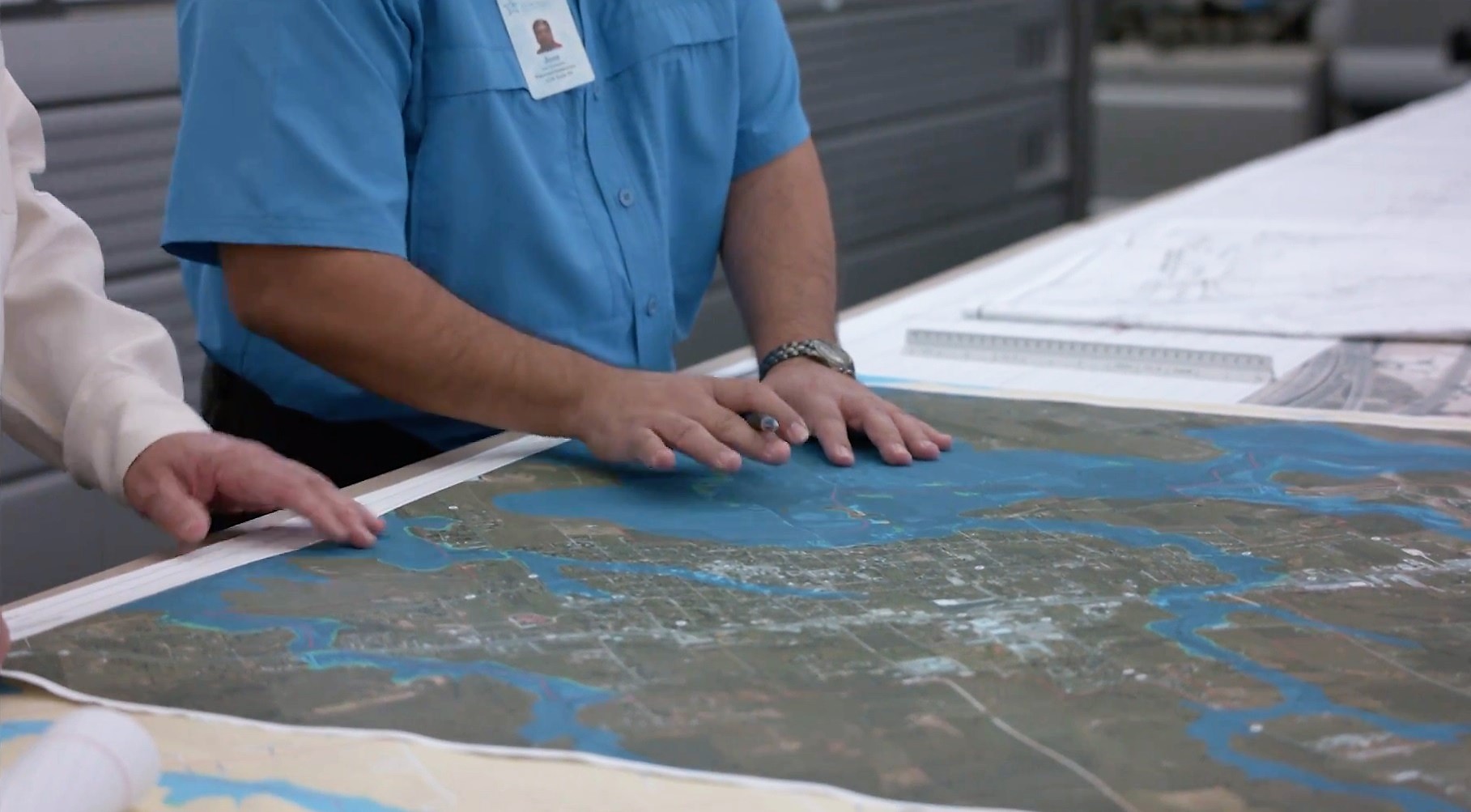 Picture of Scientists working with maps and data to mitigate flooding.