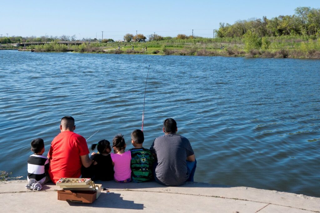 Family fishing on the Mission Reach San Antonio River Walk segment.
