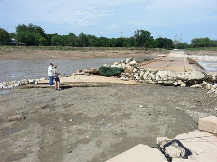 River Authority staff inspect damage to the Mission Parkway low water crossing following the Memorial Day Weekend flood of 2013.