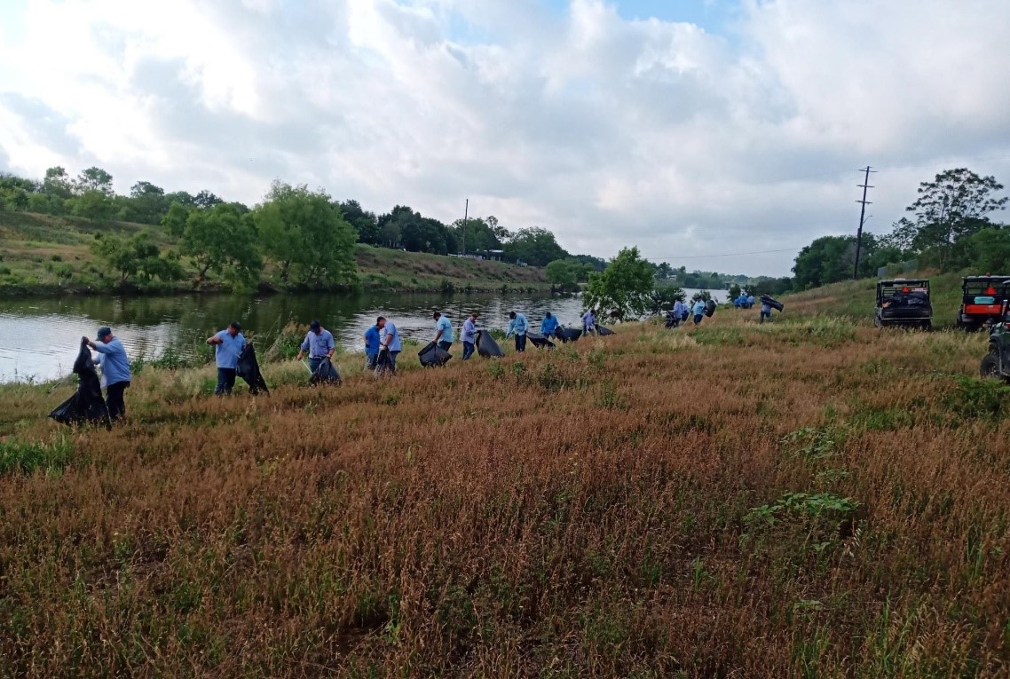 River Authority's Watershed & Park Operations staff picks up trash on the Mission Reach of the San Antonio River Walk following a storm event.