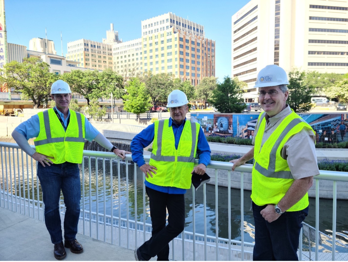 General Manager Derek Boese, Chairman of the Board Jim Campbell and Assistant General Manager Steve Graham stand in front of the construction zone of the San Pedro Creek Culture Park Project.