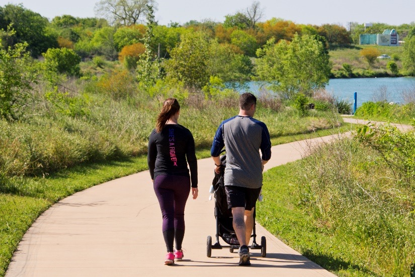 Two people strolling along the Mission Reach Walking trail. 