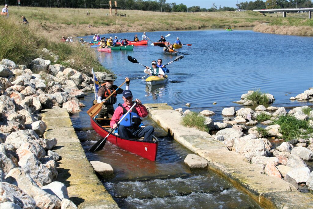 Kayakers float down the mission reach part of the San Antonio River.