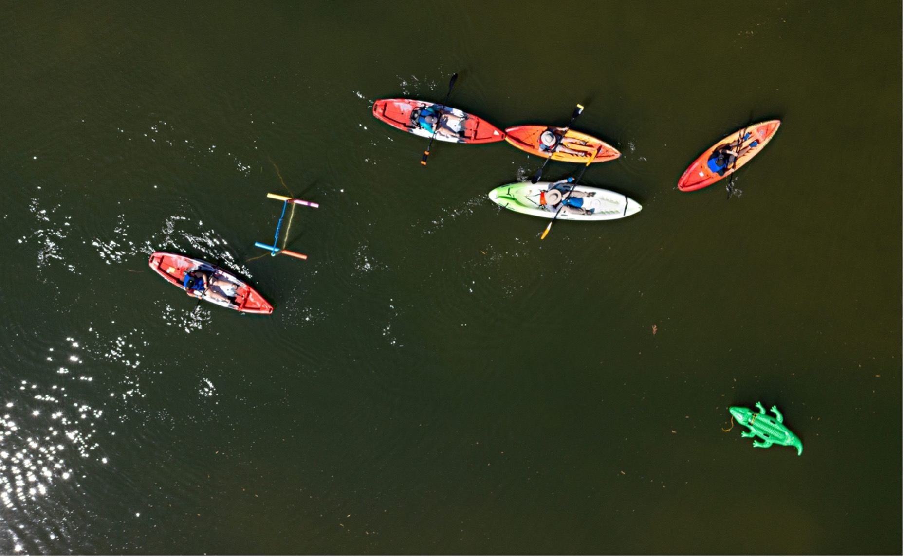 Aerial view of kayakers floating down the San Antonio River during Floatilla event.