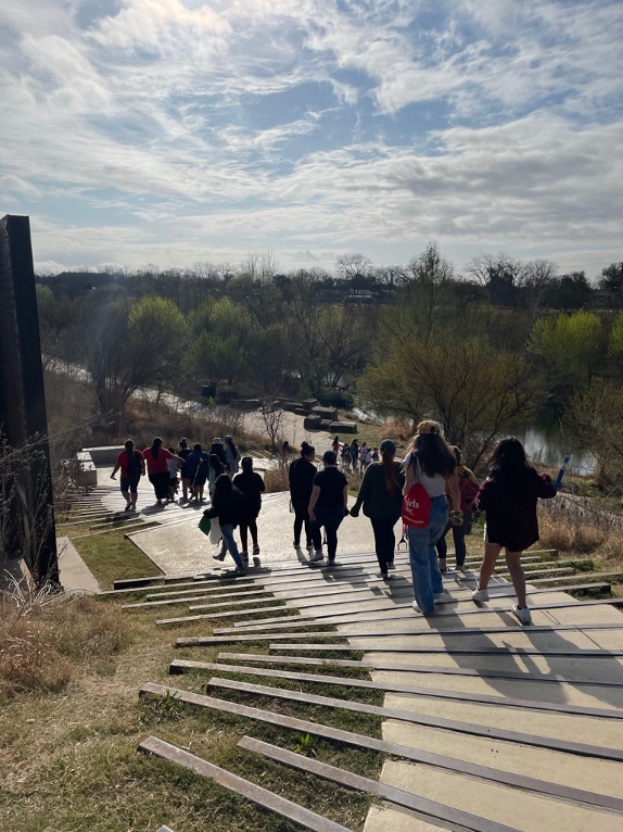 Students at Confluence Park travel down the stairs towards the San Antonio River.