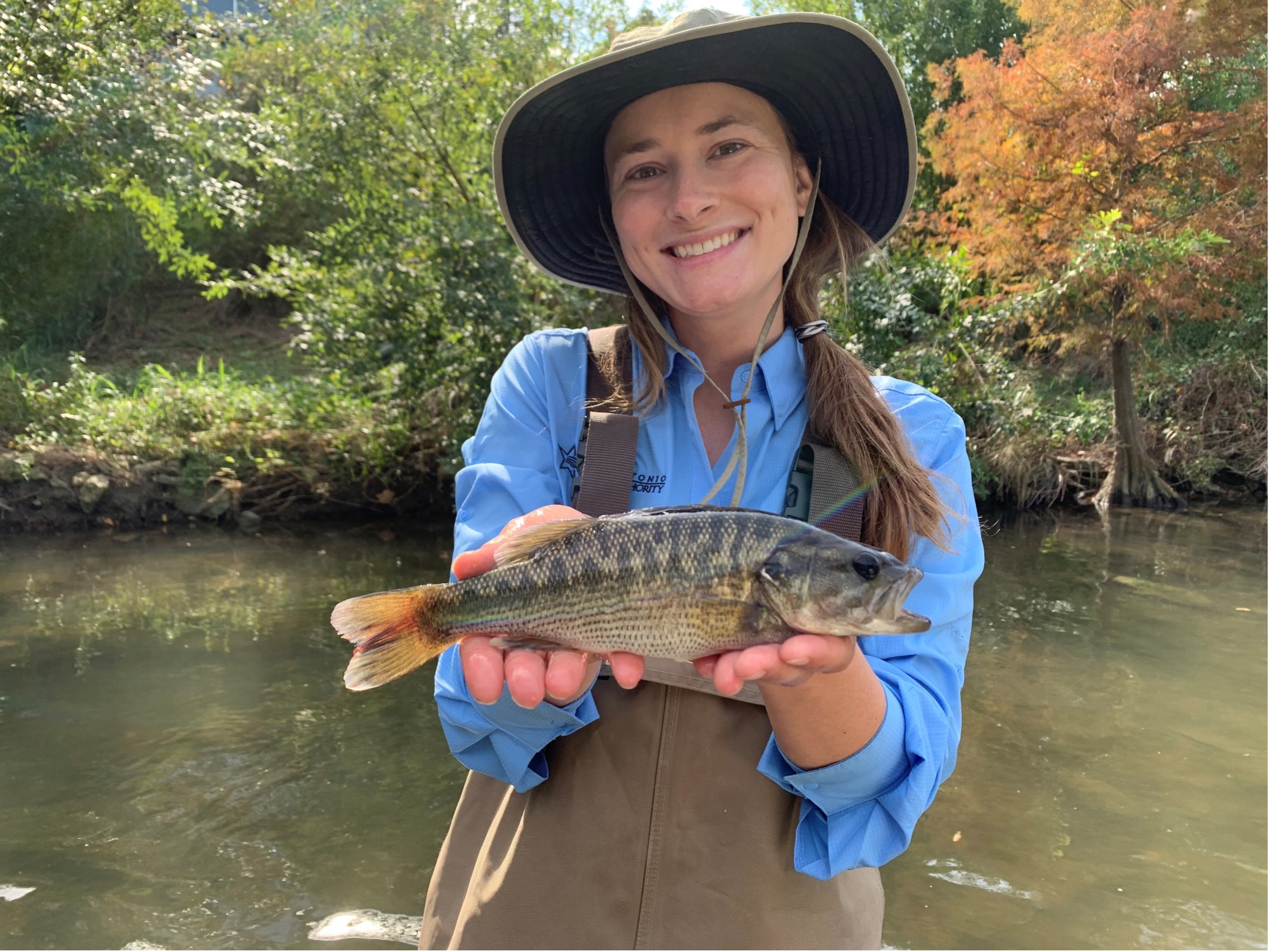 Aquatic biologist Zoe Nichols holds the State Fish of Texas, the Guadalupe bass (Micropterus treculii).