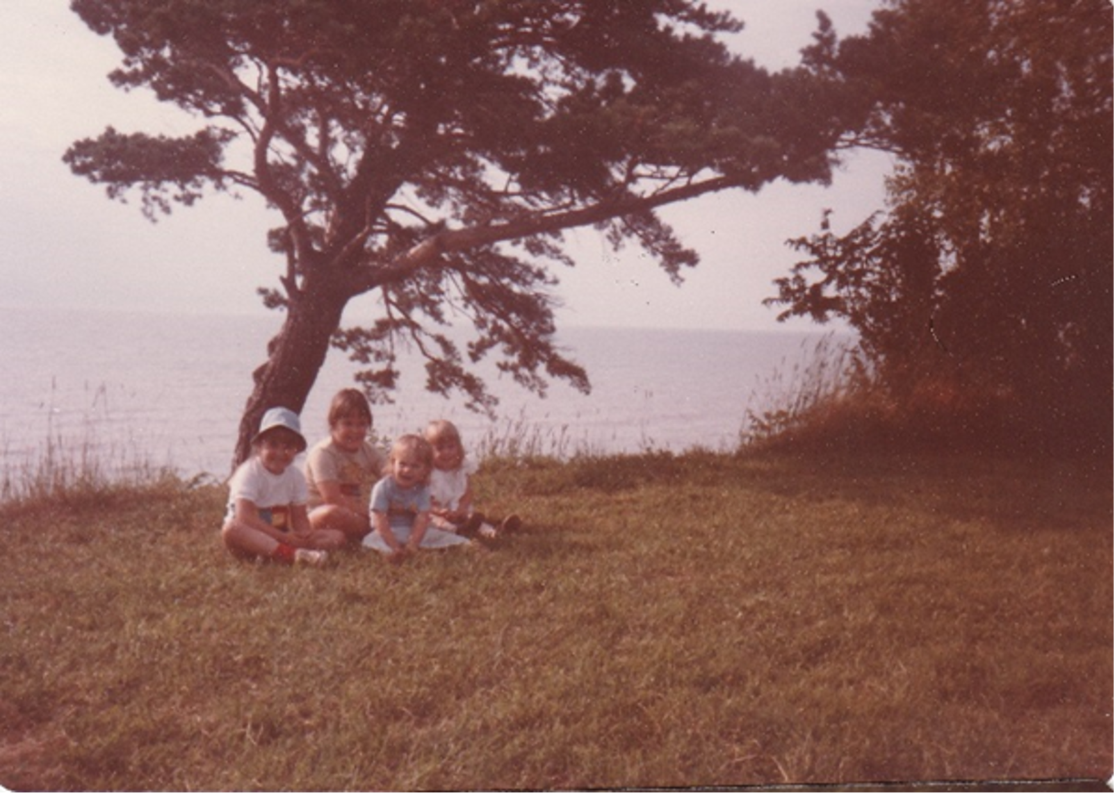 Four young children sit beside Lake Eerie.