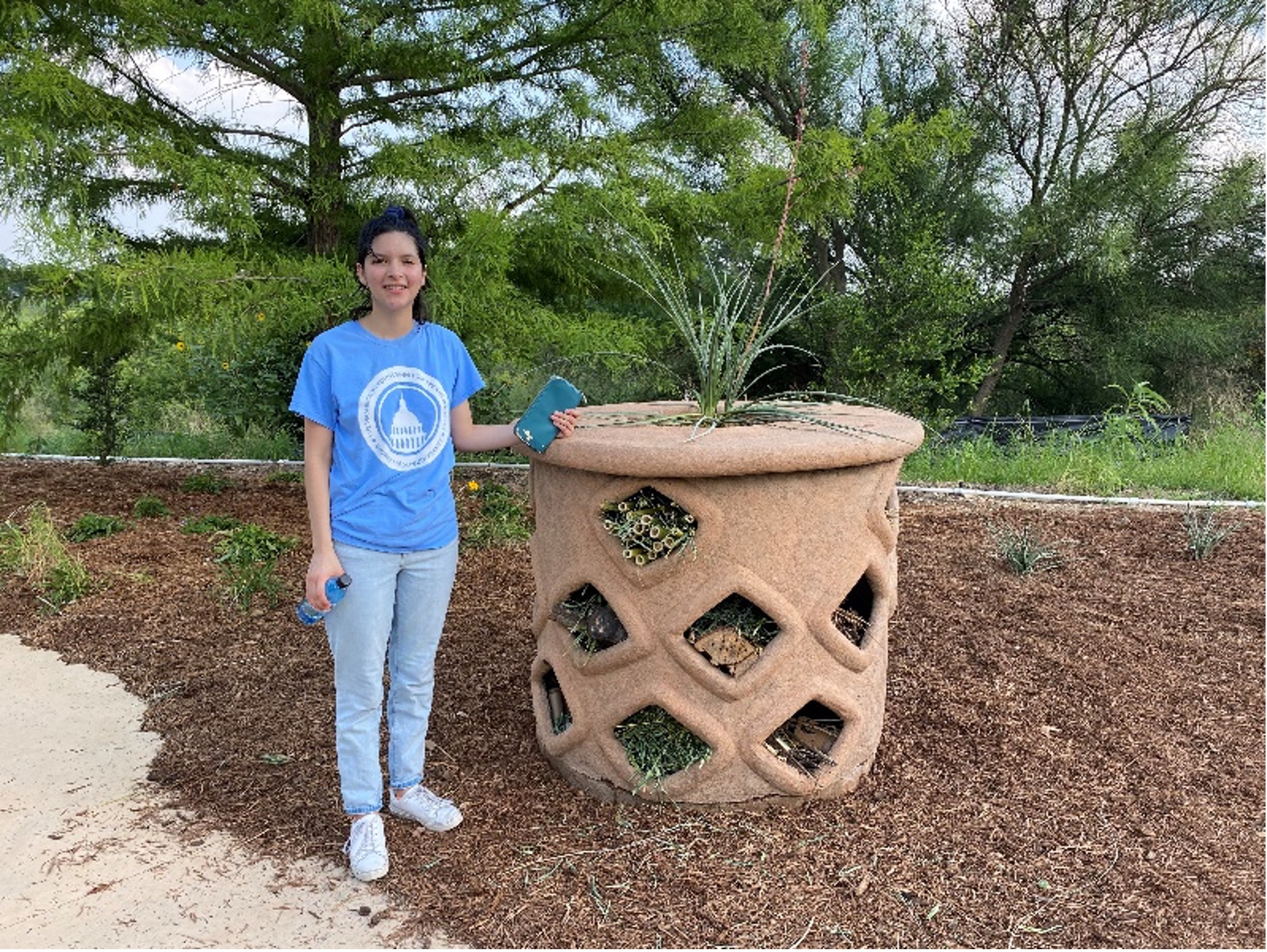 Student intern Paloma Jimenez with the insect hotel. 