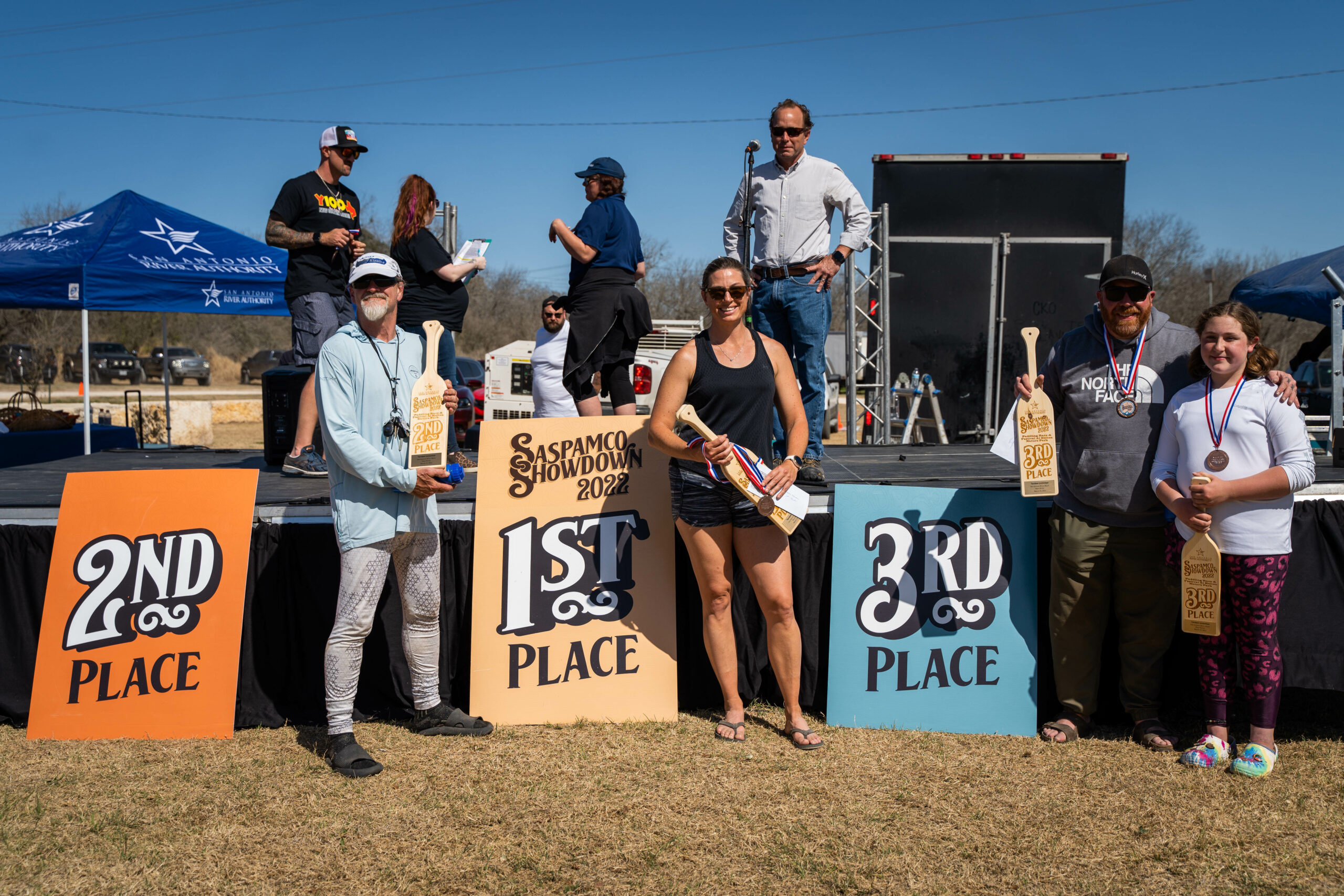 Winner pose next to the stage for the SASPAMCO Showdown Paddling Race. 