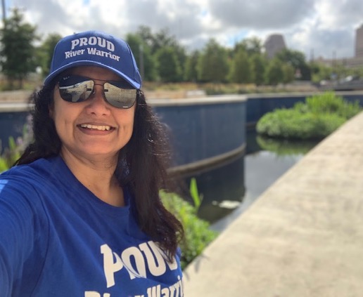 Education and Volunteer Engagement Coordinator Minna Paul takes a photo in front of San Pedro Creek Culture Park