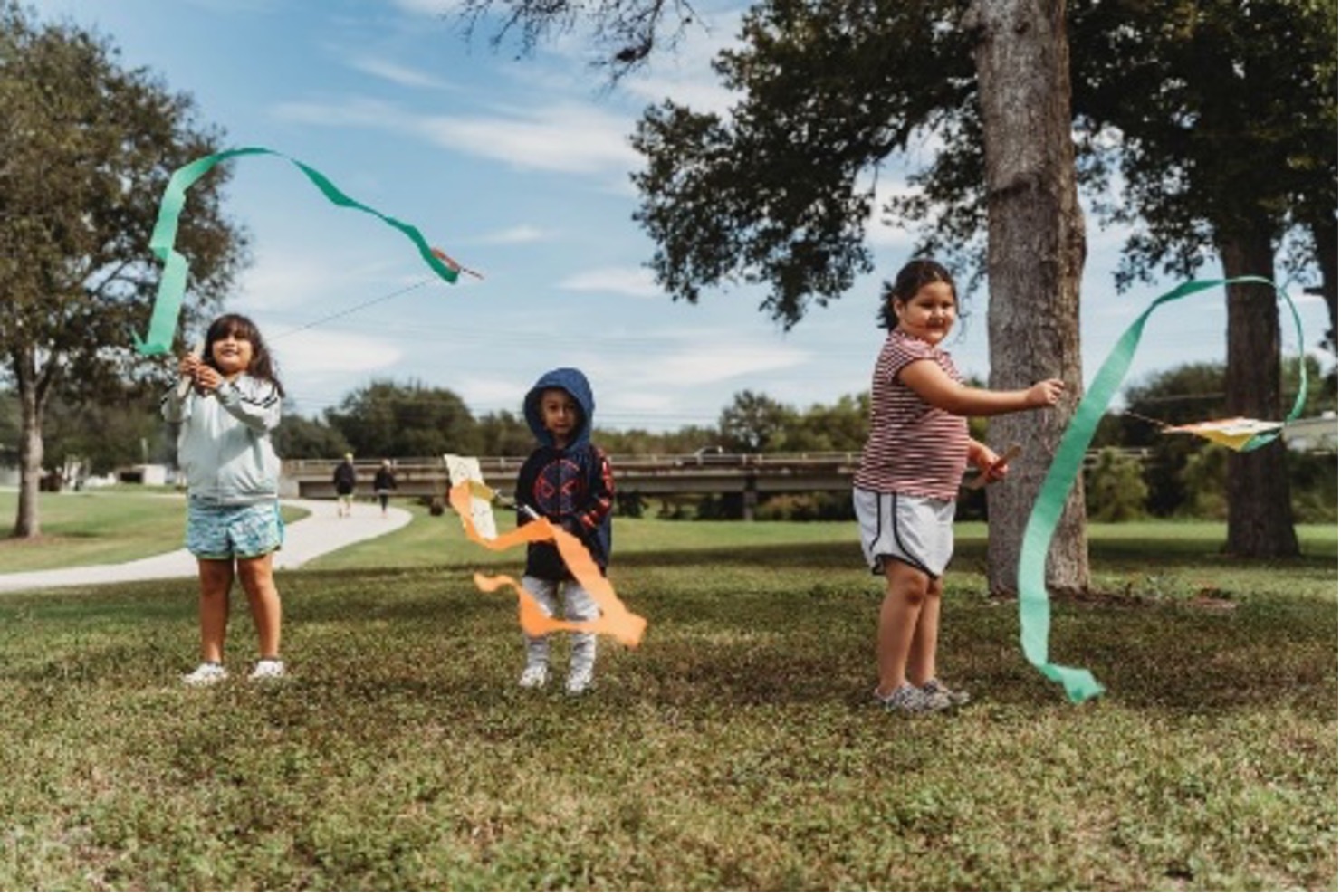 Children stream colorful streamers in the air at Escondido Creek Parkway