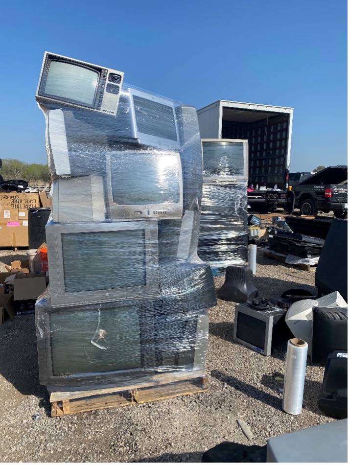 Older box TV's wrapped in plastic cling wrap.