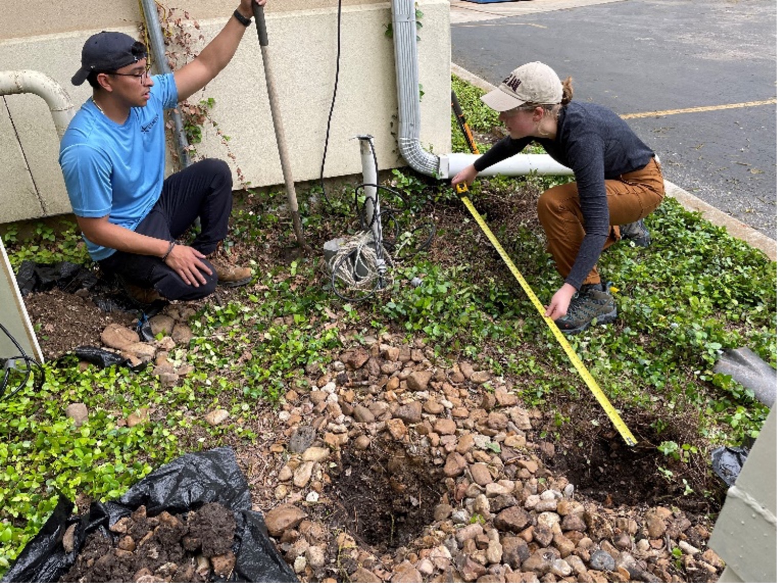 Environmental Scientists measure stormwater drains for water quality monitoring.