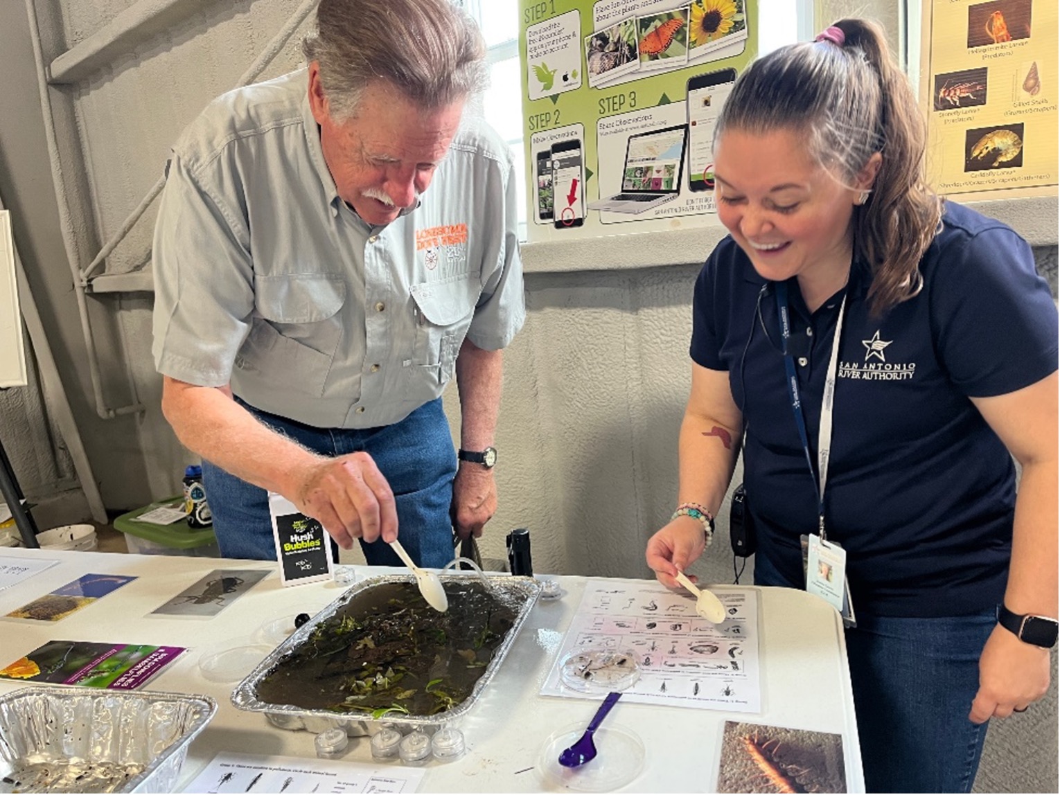 Board member Trip Ruckman and Janine Garcia observe arthropods in the soil.