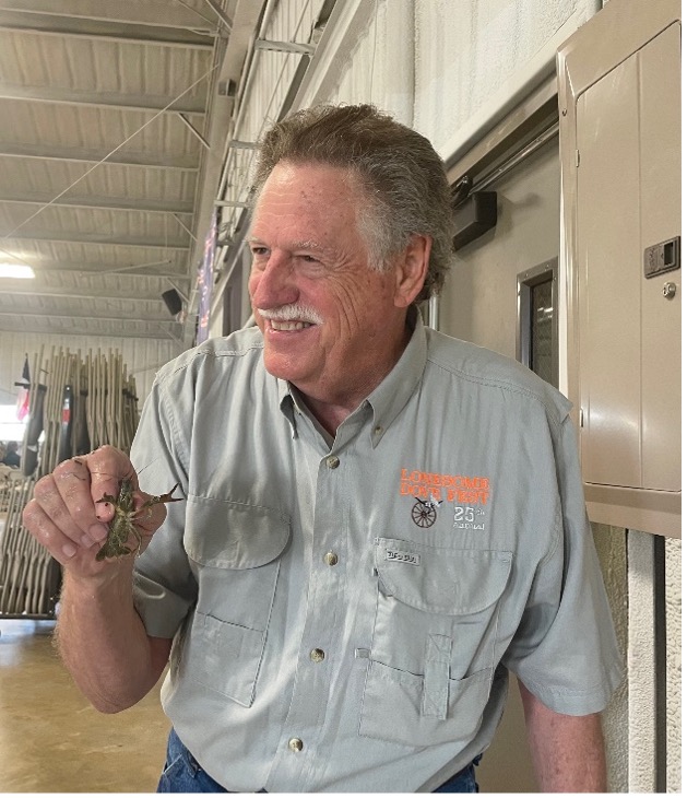 Board Member Ruckman holds crawfish.