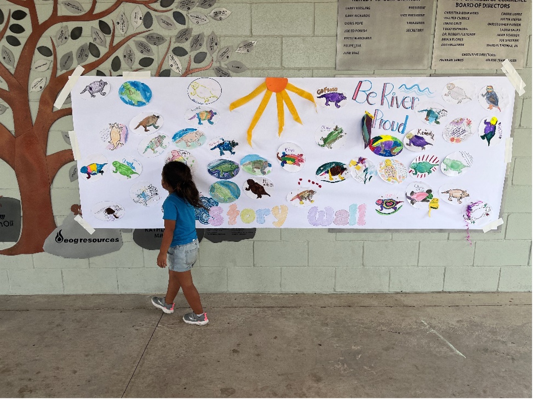 A Child admires the display of hand drawn horned lizards at Escondido Creek Parkway