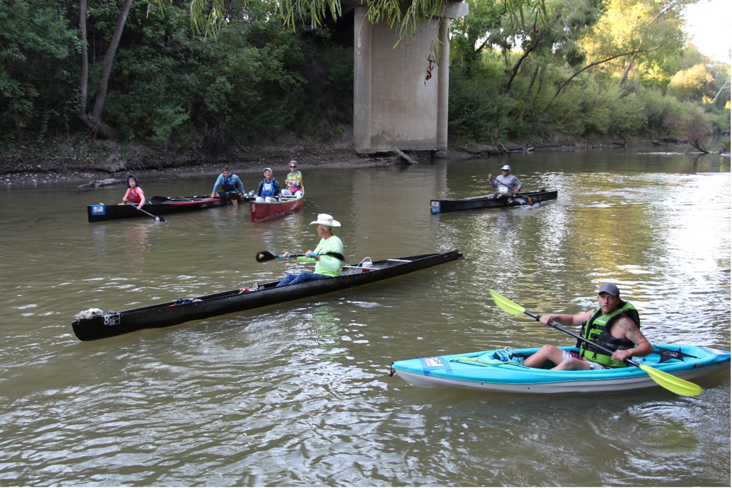Goliad Paddling Race shows racers floating on the river