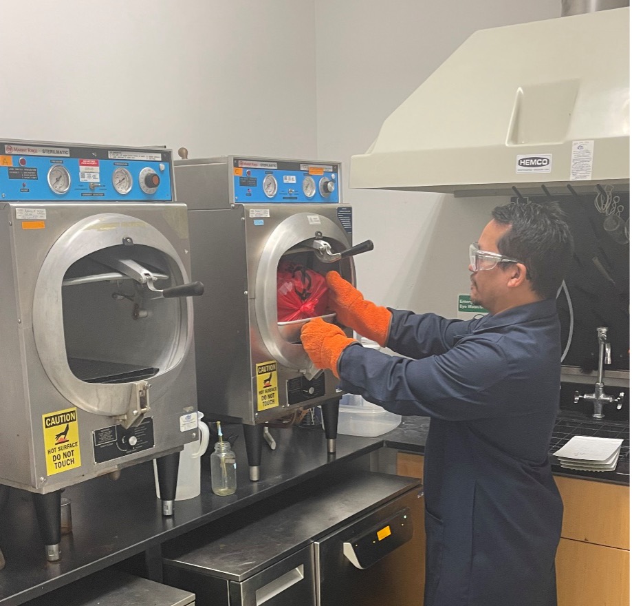 Greg Mateo sterilizes E. coli samples ready for disposal.