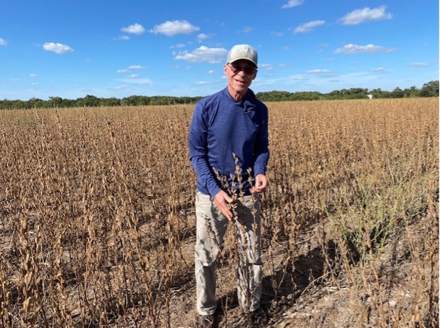 Dr. James Fuller stands in a wide field