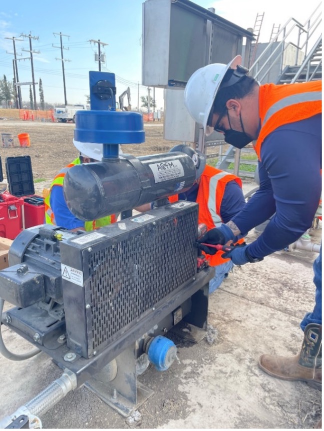 Maintenance staff servicing a blower