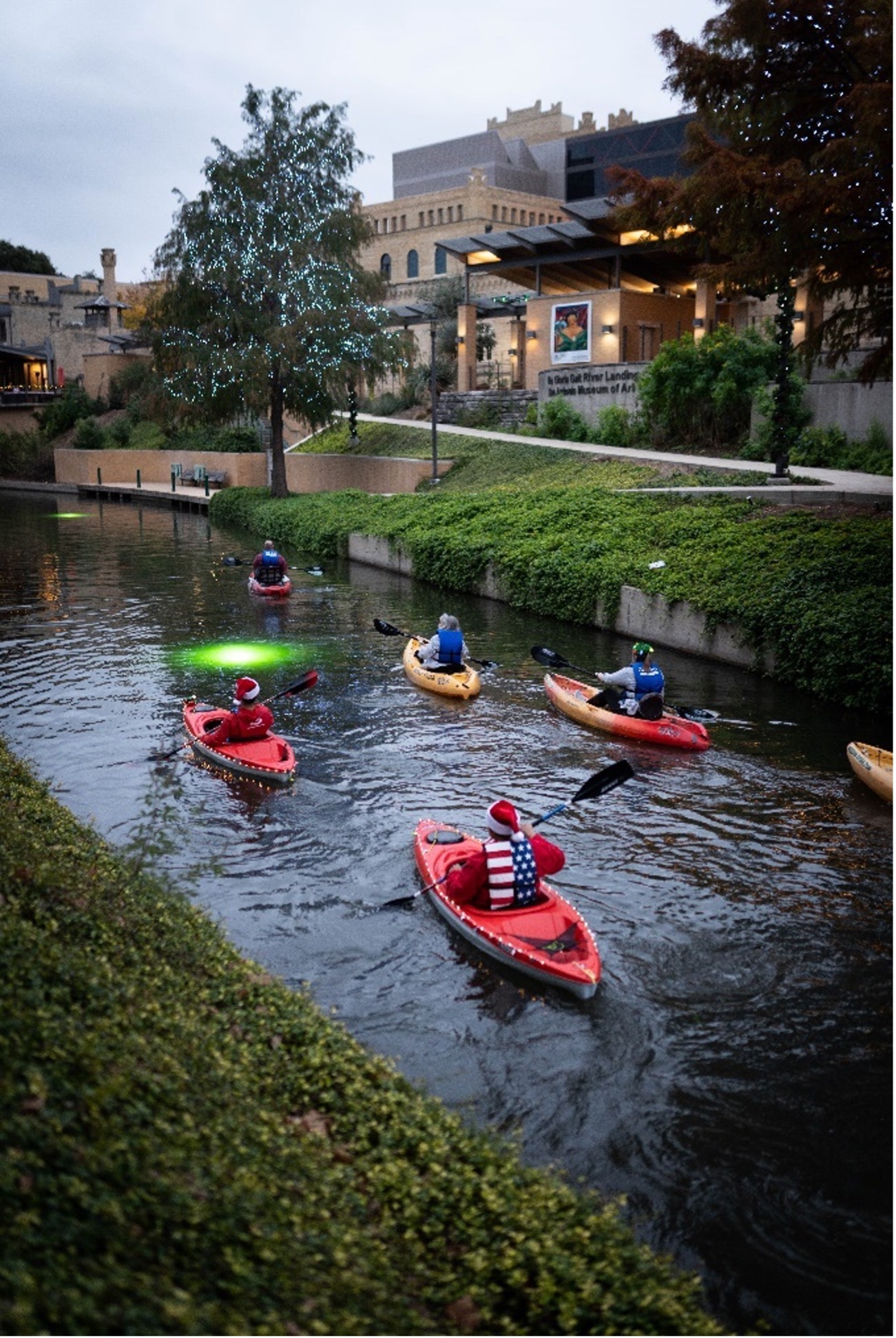 Participants paddle down the Museum Reach during the River of Lights kayak event