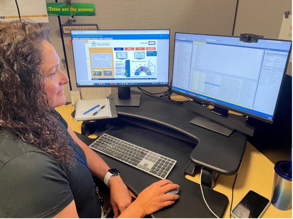 Environmental Scientist sits in from of computer to document data.