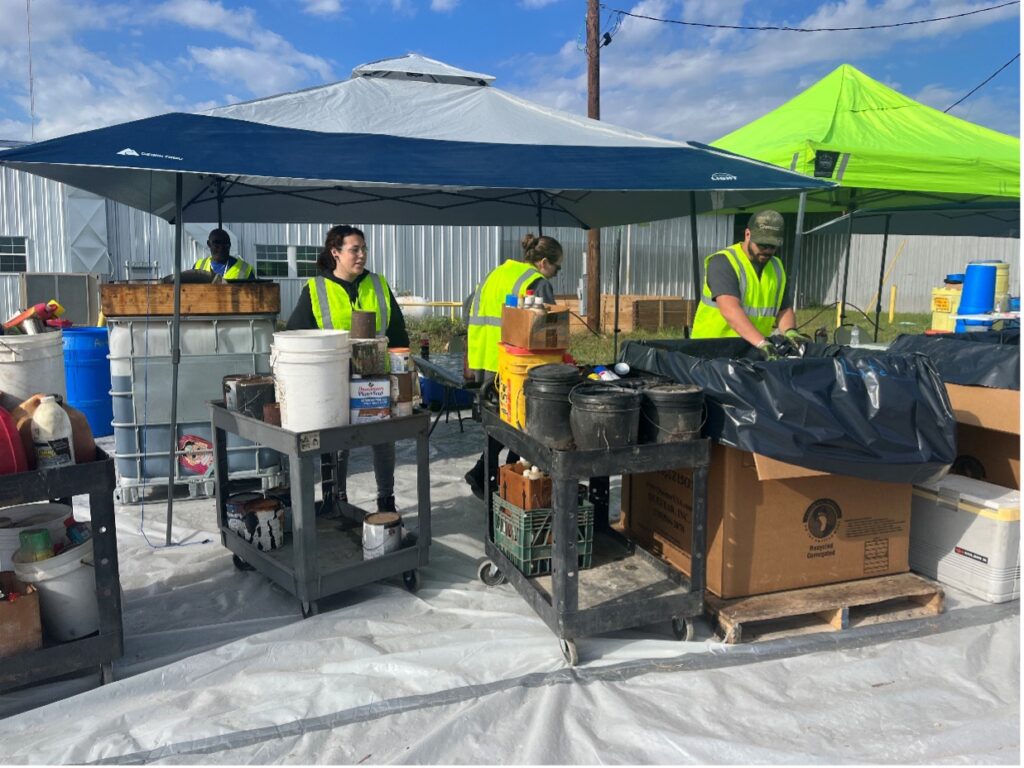 Workers collect and sort household hazardous materials.