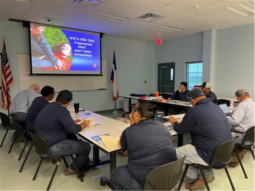 Team member gather to watch CPR Training Presentation