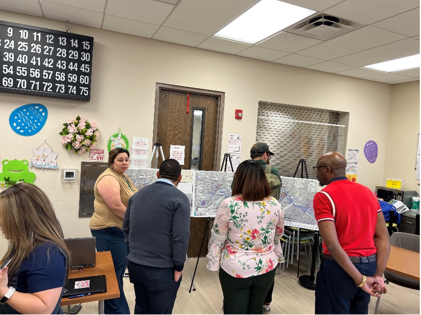 Members of the public gather around visual displays of the new draft floodplain maps