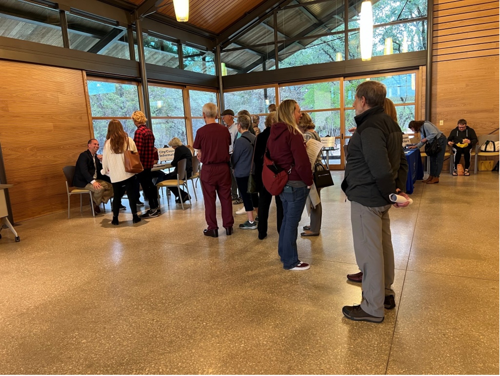 Members of the public wait patiently to speak with ecological engineers about the draft floodplain maps