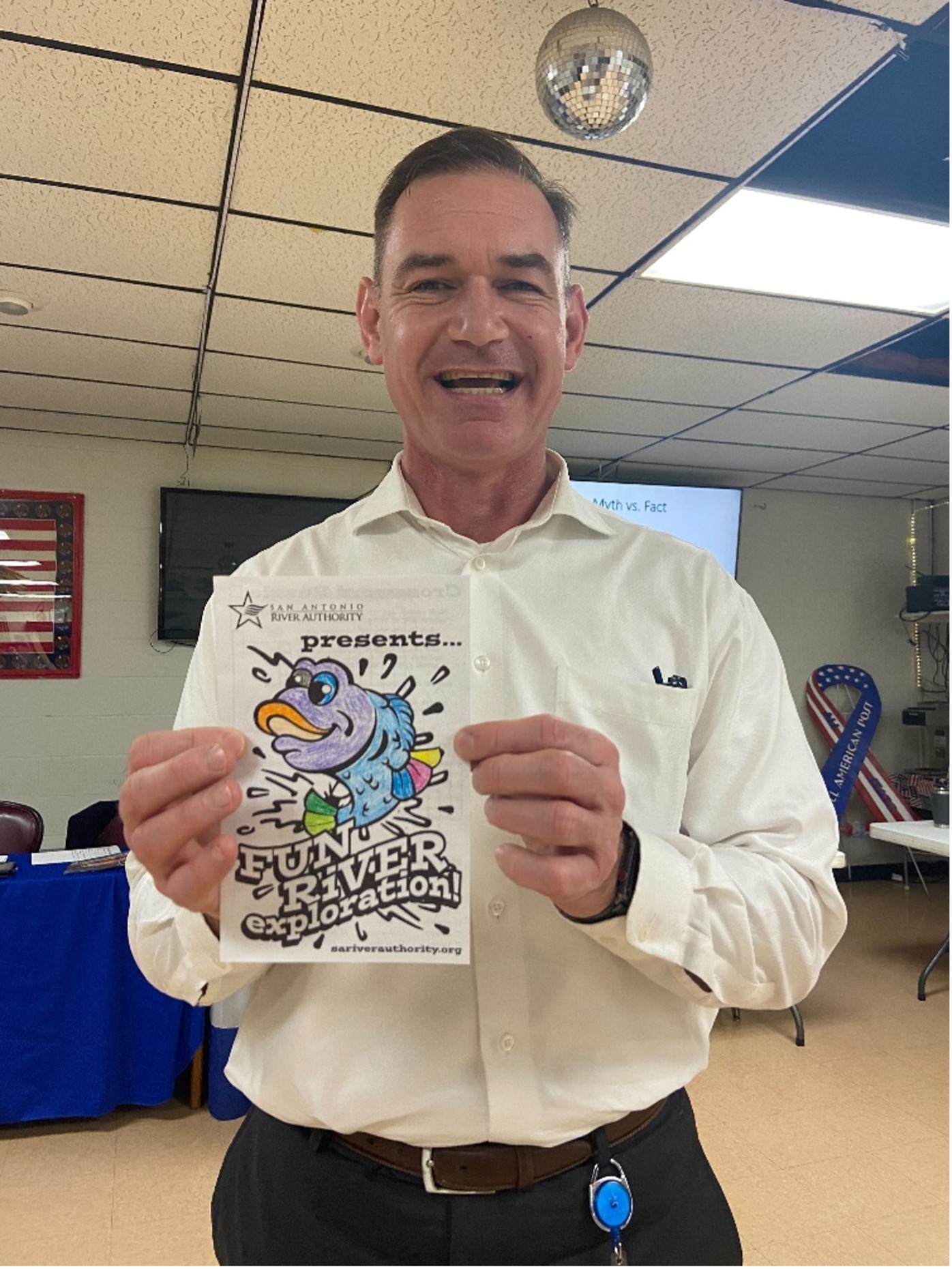 General Manager Derek Boese holds up completed activity coloring book