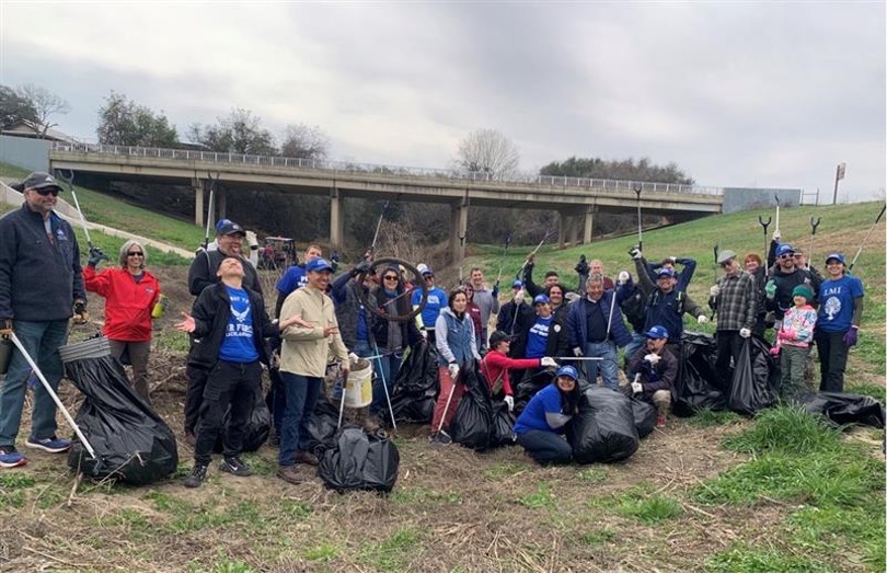 River Warrior Volunteers cheer after a successful river clean up event