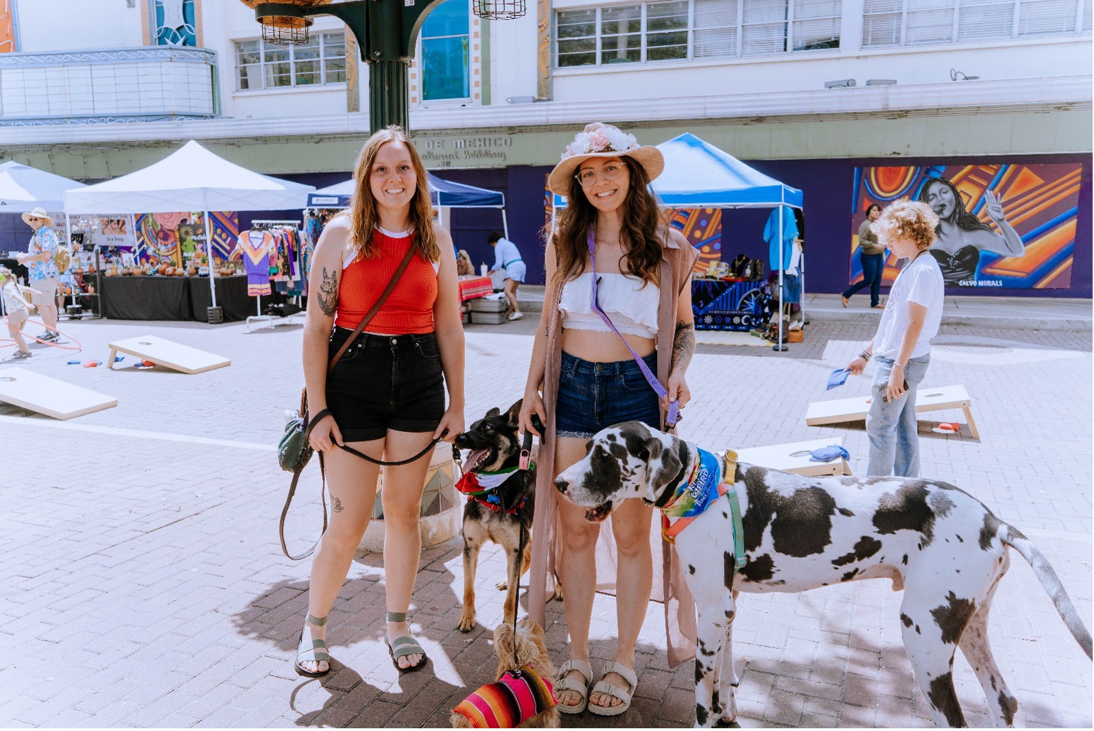 Two women stand with there dogs during Creekfest event