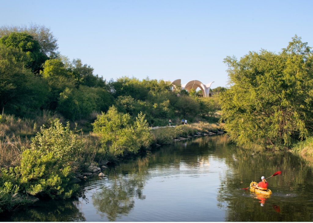 Kayaker approaches Confluence Park along the San Antonio River Mission Reach