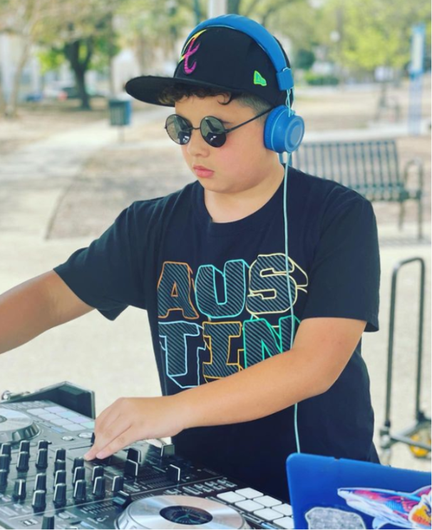 Boy plays with DJ equipment