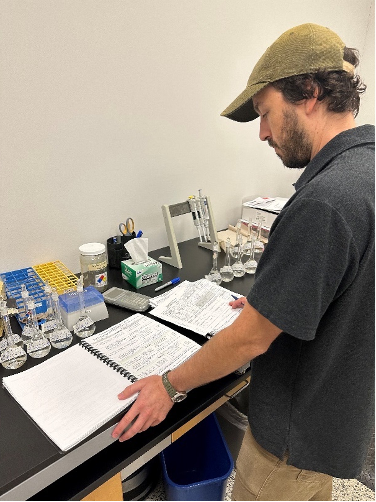 Scientists reviews papers on lab bench. 