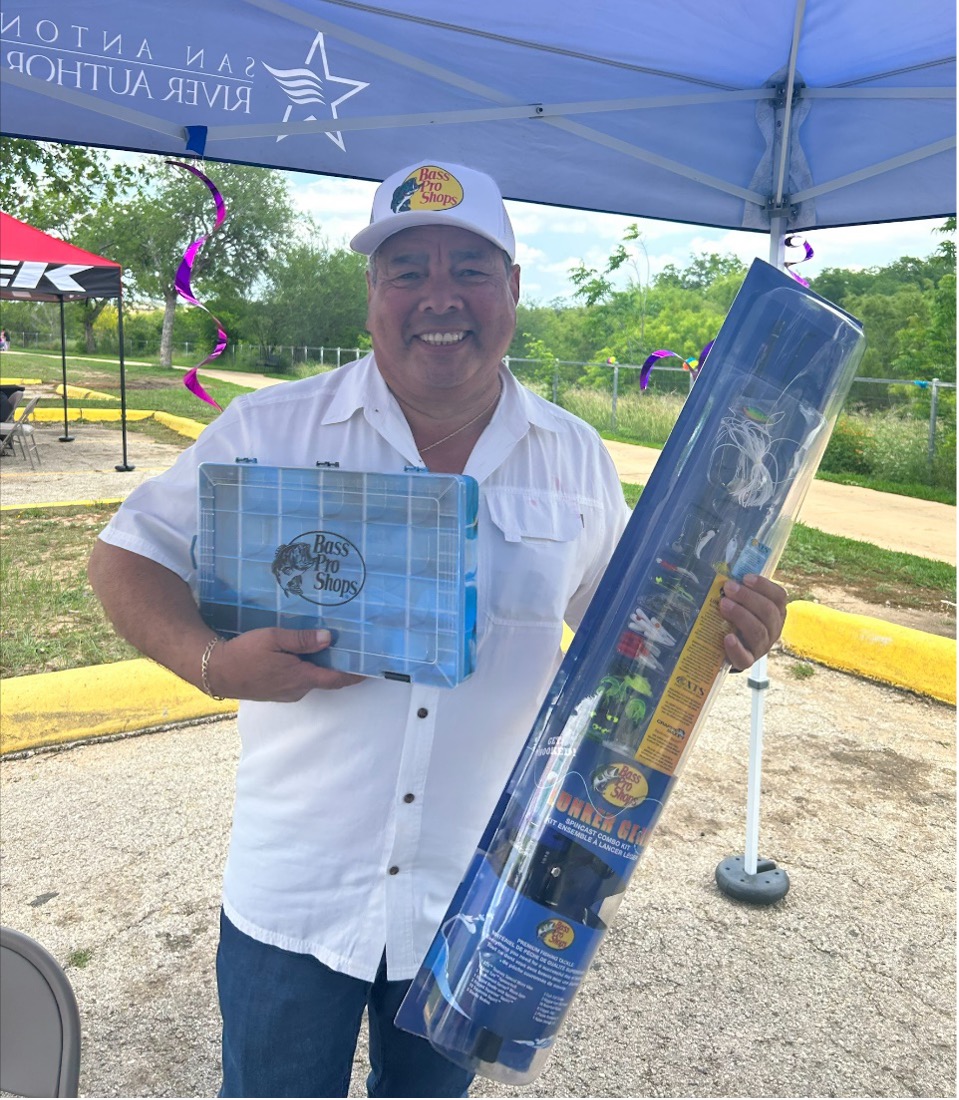 Board Member Jerry Gonzales poses with fishing gear.