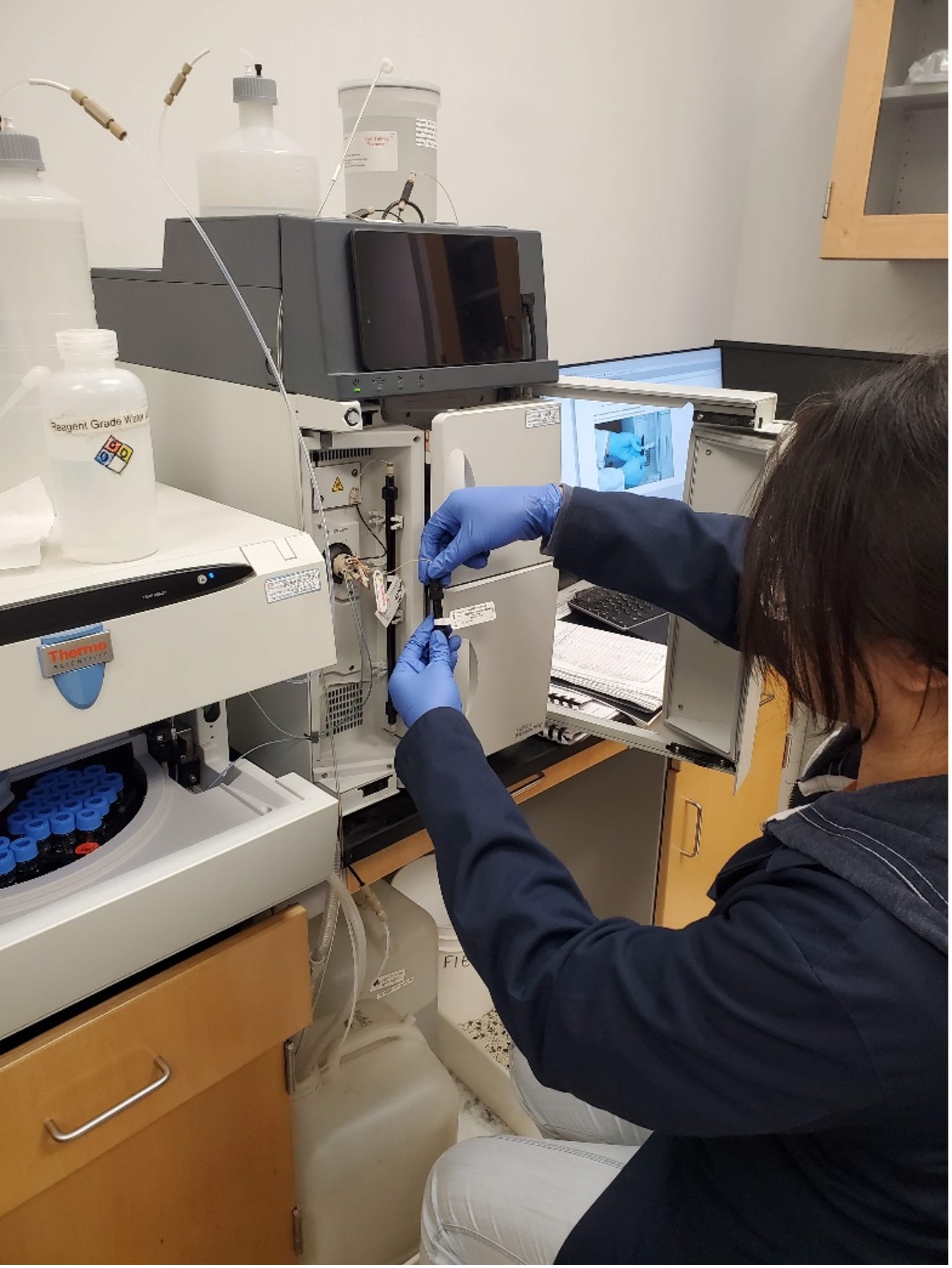 Scientist takes out samples from machine during maintenance. 