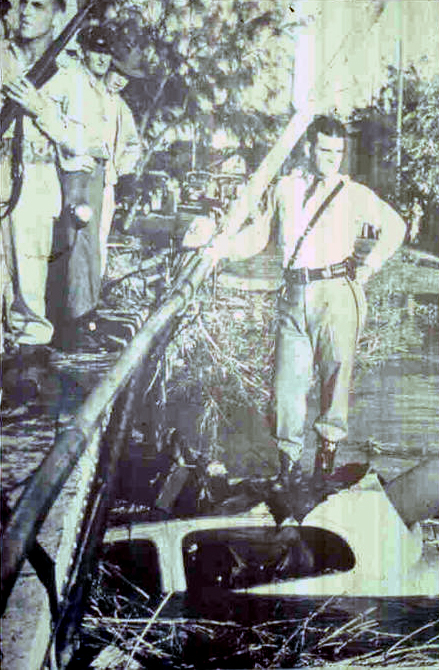 Historic photo of police officer atop flooded car