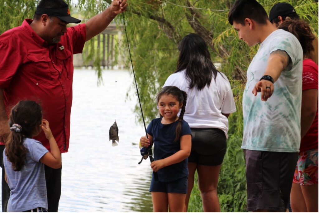 family fishing with little girl smiling