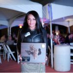 Woman holds award plaque