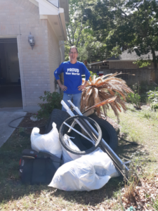 River Warrior stands behind piles of trash