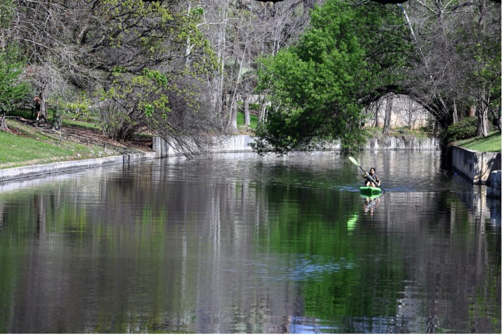 A kayaker rowing down the San Antonio River
