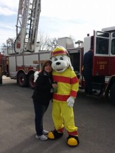 Kim Garcia stands next to mascot.