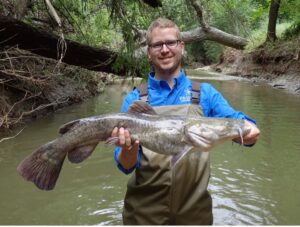 River Authority scientist holds a catfish