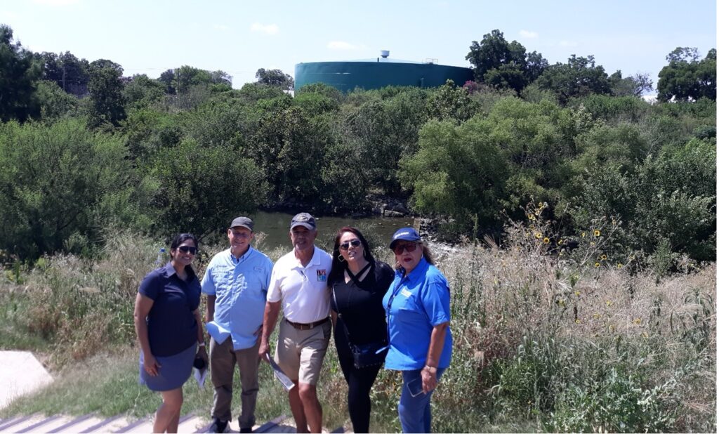 A group of people stands by the Mission Reach Ecosystem project.