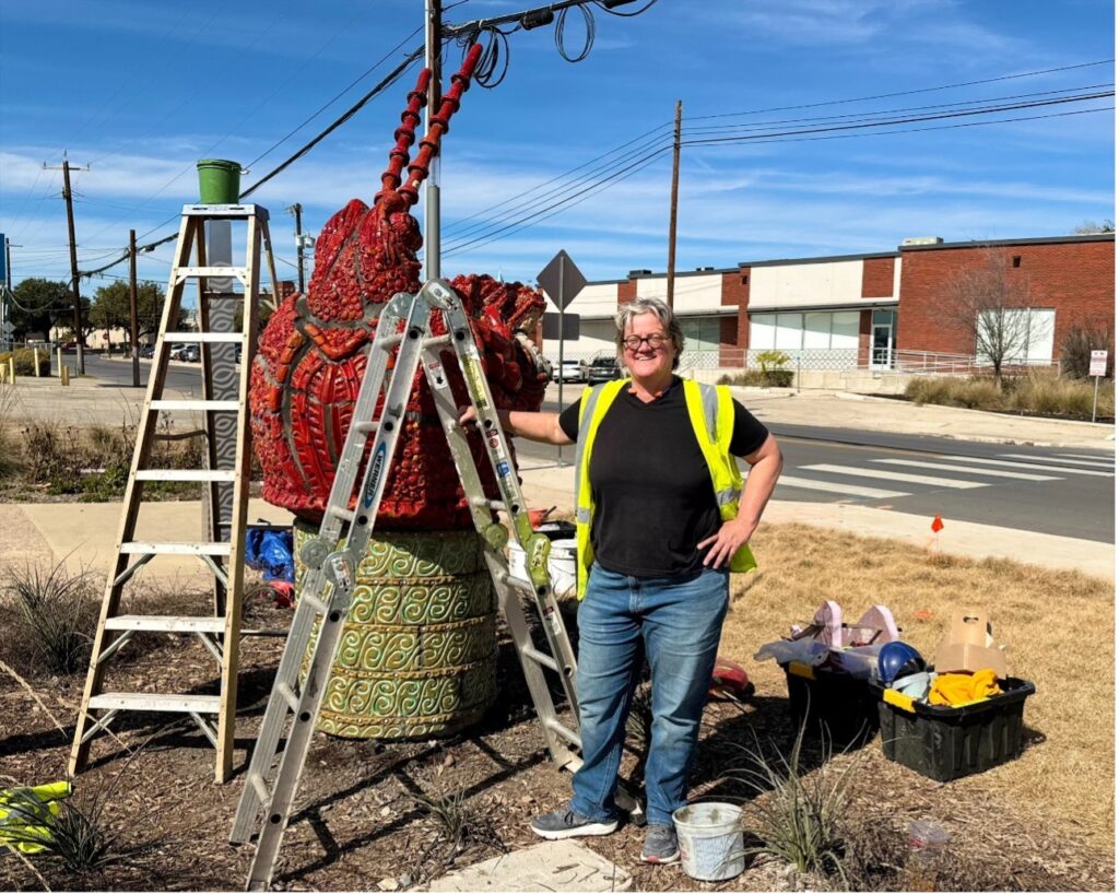Artist Diana Kersey poses next to her Crayfish sculpture.