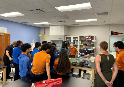 Student gather around lab bench for demonstration