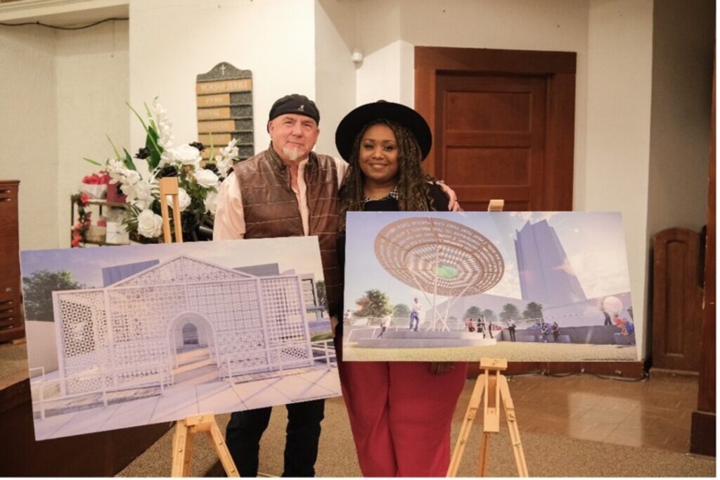 Two artists stand next to each other